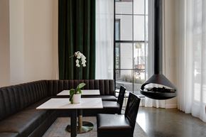 Richmond apartment for rent - A modern dining room with a black booth and a white table.