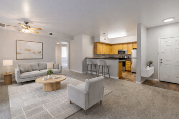 San Ramon apartment for rent - A living room with a grey couch, a wooden coffee table, and a painting on the wall.