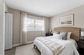 Carrboro apartment for rent - A bedroom with a large bed and a painting on the wall.