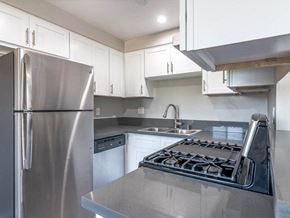 Whittier apartment for rent - a kitchen with stainless steel appliances and white cabinets at Citrus Court Apartments, Whittier