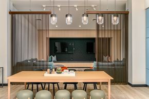 Gresham apartment for rent - A modern dining room with a wooden table and grey chairs.