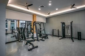 Gresham apartment for rent - A gym with a variety of equipment including weights and a bench.