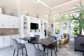 Pleasanton apartment for rent - A modern kitchen with a dining table and chairs.