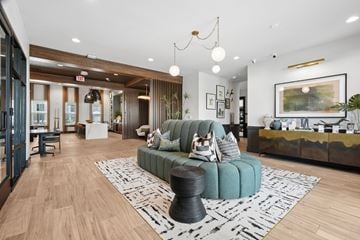 Pooler apartment for rent - A living room with a green couch and a wooden floor.