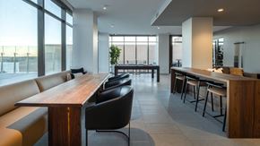 Madison apartment for rent - A modern dining area with a long wooden table and black chairs.