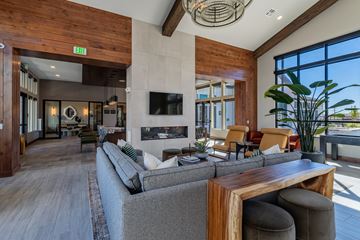 Broomfield apartment for rent - A modern living room with a grey sofa and a wooden coffee table.