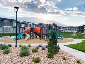 Pleasant Grove townhouse for rent - A playground with a slide and a tree in the foreground.