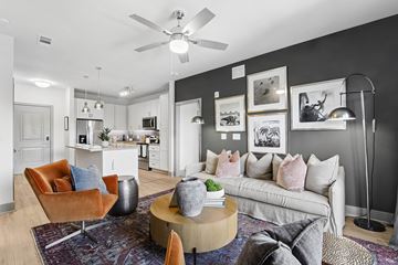 Decatur apartment for rent - A living room with a white couch and a brown chair.