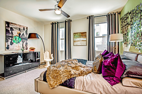 Las Vegas apartment for rent - a bedroom with a large bed and a dresser with a tv on top of it