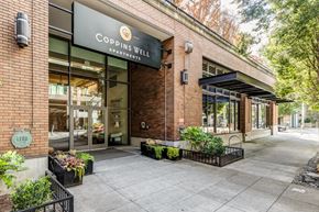 Seattle apartment for rent - the facade of a building with a sign that reads Coppins Well Apartments