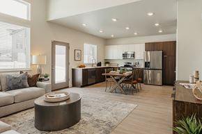 South Jordan townhouse for rent - Open living room and kitchen with dining table and chairs at Rise South Jordan townhomes.