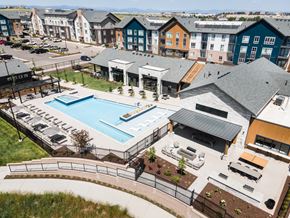 Parker apartment for rent - A large outdoor swimming pool surrounded by a black fence and a small building.