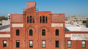 Philadelphia apartment for rent - A red brick building with a sign that says "Red Bell Brew".