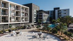 Marina Del Rey apartment for rent - A modern building complex with a pool and outdoor furniture.