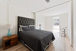 Oakland apartment for rent - a bedroom with a large bed and a desk