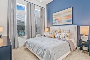 Denton apartment for rent - A bedroom with a large bed and a painting on the wall.