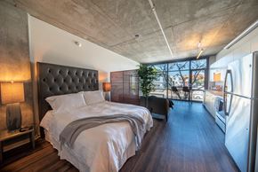 San Diego apartment for rent - A bedroom with a large bed and a view of the city.