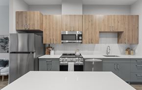 Warwick apartment for rent - A modern kitchen with wooden cabinets and stainless steel appliances.