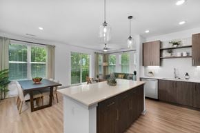 Charlotte apartment for rent - A modern kitchen with a dining table and chairs.
