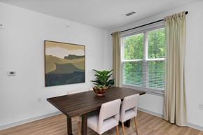 Charlotte apartment for rent - A dining room with a wooden table and chairs.