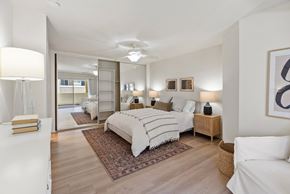 Aliso Viejo apartment for rent - A bedroom with a large bed and a mirror on the wall.