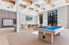 Allen apartment for rent - A billiard table is in the middle of a room with a pool table.