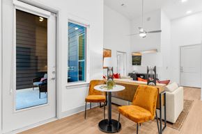 Allen apartment for rent - A modern dining room with a glass table and chairs.