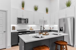 Allen apartment for rent - A modern kitchen with a large island and stools.