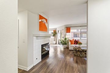 Aliso Viejo apartment for rent - A living room with a fireplace and a painting on the wall.
