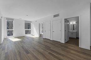 Philadelphia apartment for rent - A spacious room with wooden floors and white walls.
