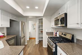 Aliso Viejo apartment for rent - A kitchen with a stove top oven and a refrigerator.