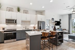 Irving apartment for rent - Open kitchen and dining area with island at Alta Riverside apartments in Irving, TX.