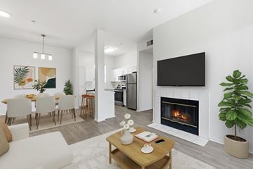 San Diego apartment for rent - A modern living room with a fireplace and a television mounted on the wall.