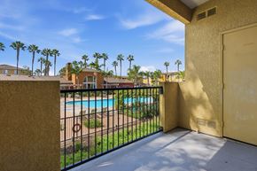 Chula Vista apartment for rent - A balcony with a pool and palm trees in the background.