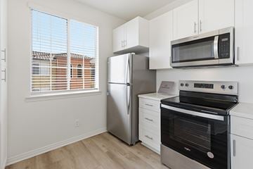 Chula Vista apartment for rent - A kitchen with a stainless steel refrigerator, oven, and microwave.