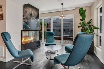 San Diego apartment for rent - a living room with blue chairs and a fireplace