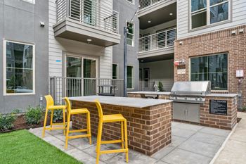 Covered outdoor kitchens with grills and dining areas