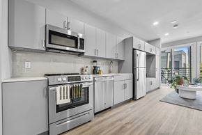 Philadelphia apartment for rent - a kitchen with white cabinets and stainless steel appliances