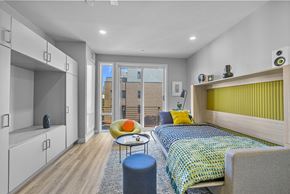 Philadelphia apartment for rent - a bedroom with a bunk bed with a yellow headboard and a blue and yellow bedspread
