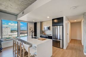 Denver apartment for rent - a kitchen with a large island and a stainless steel refrigerator