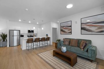 Cedar City apartment for rent - A living room with a green couch and a wooden coffee table.