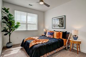 Greeley apartment for rent - a bedroom with a bed and a ceiling fan