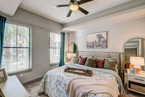 Tempe apartment for rent - A bedroom with a large bed and a ceiling fan.