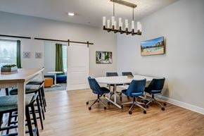 Baton Rouge apartment for rent - A conference room with a white table and blue chairs.