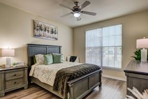 Baton Rouge apartment for rent - A bedroom with a bed, nightstand, and a painting on the wall.