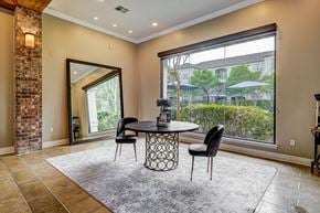 Baton Rouge apartment for rent - A dining room with a table and chairs and a large window.