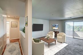 Concord apartment for rent - A living room with a flat screen TV and a balcony.