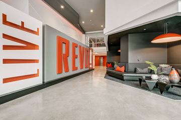 Anaheim apartment for rent - A modern living room with a large couch and a sign that says "REVIEW".