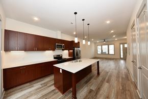 Lebanon apartment for rent - A kitchen with brown cabinets and a white island.
