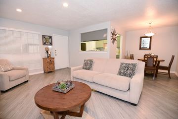 Houston apartment for rent - A living room with a white couch and a wooden coffee table.